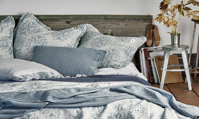 The soft tones of the Amalfi Coast are translated here in the multiple shades of blue, the varied textures of linen and cotton and the romance of a gorgeous print on linen - Bedding by Traditions Linens.