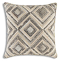 Featuring different textured gold and silver metallic printed decorative pillows.