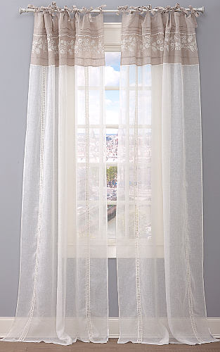 This decorated sheer drapery has beautiful medallions strategically placed to create an incredible atmospheric room setting.