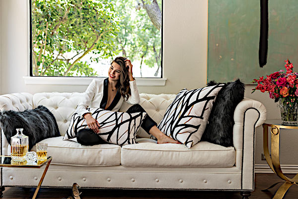 Lili Alessandra Black Faux Throw and Decorative Pillows with model.