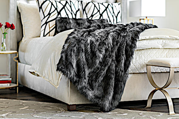 Lili Alessandra Black Faux Throw and Decorative Pillows - draped over bed.