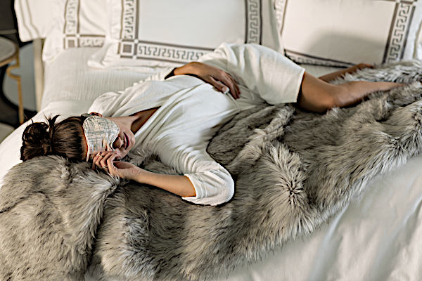 Lili Alessandra Silver Faux Throw and Decorative Pillows - Model Laying on Throw.