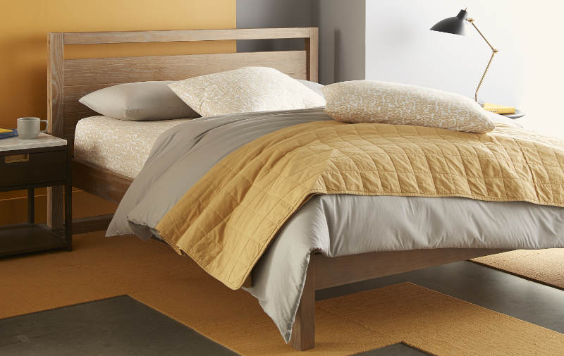 Quilted washed percale coverlet with a relaxed look.