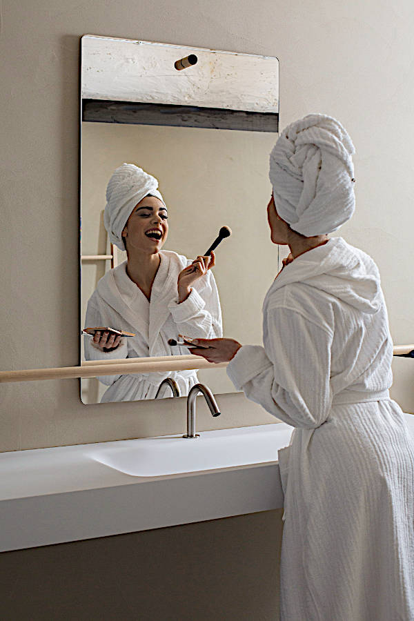 SVAD DONDI Times Square Bath - model wearing bathrobe in front of mirror.